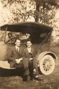 Arthur and Adam Peacock on an old car